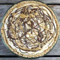 Peanut butter pie with chocolate and peanut butter drizzled over top.