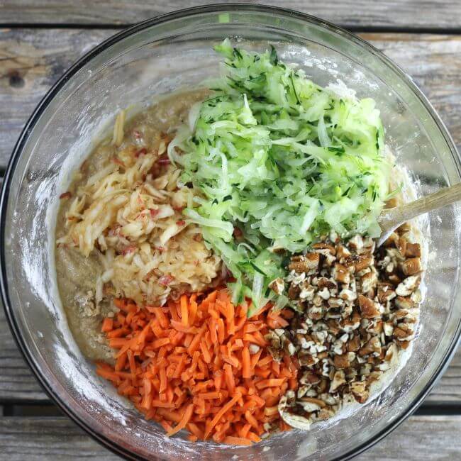 Shredded zucchini, carrots, apple, and nuts are added to the batter.