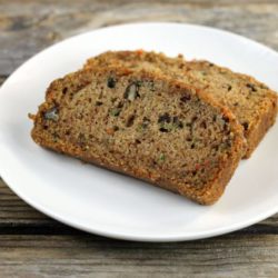 Two slice of zucchini bread on a white plate.