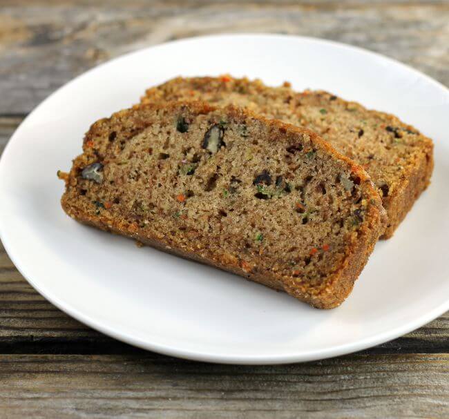Two slice of zucchini bread on a white plate.