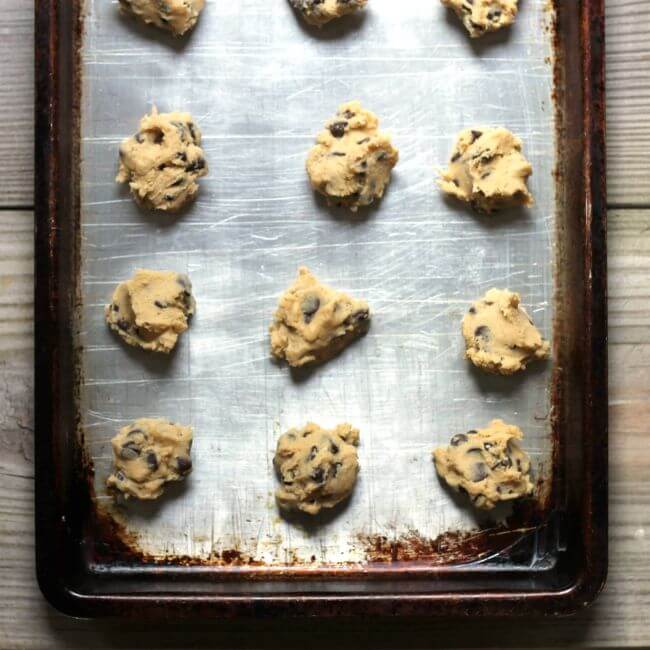 Scoops of cookie dough on a baking sheet.