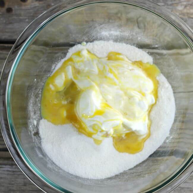 Sour cream mixture is added to the dry ingredients in a bowl.