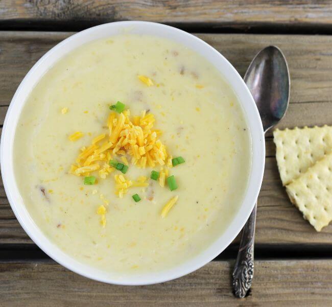 Looking down at a bowl of loaded potato soup.