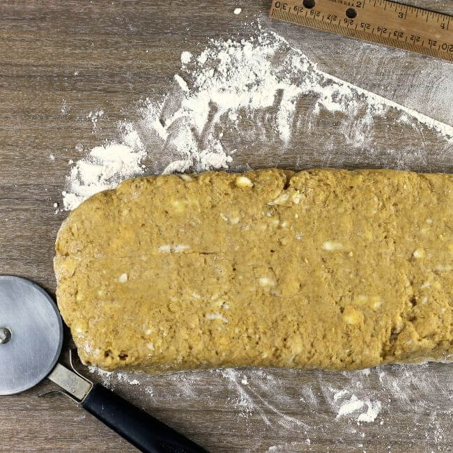 Pumpkin scone dough shaped into a rectangle.