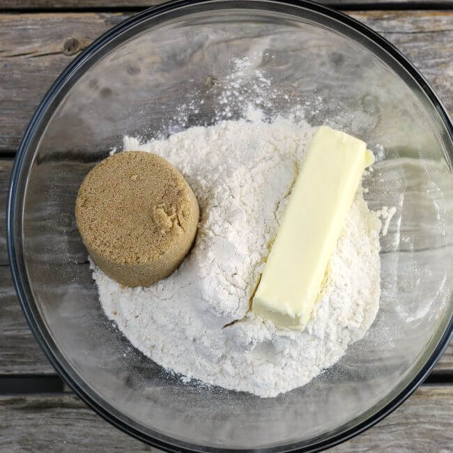 Brown sugar, butter, and flour in a glass bowl.