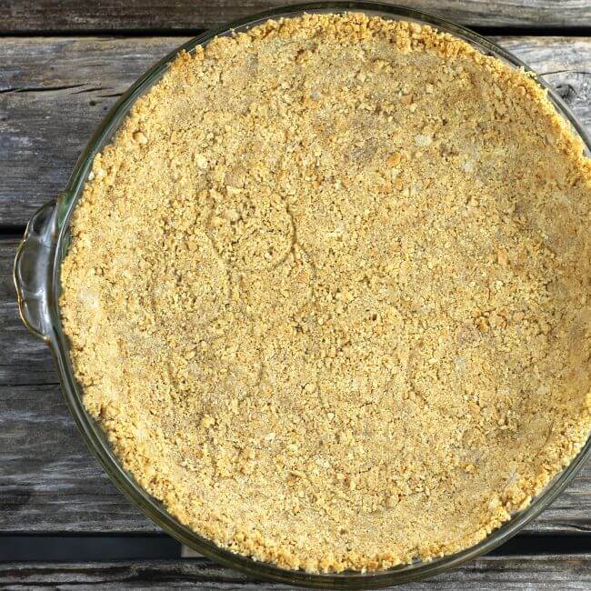 A baked graham cracker crust in a pie plate.
