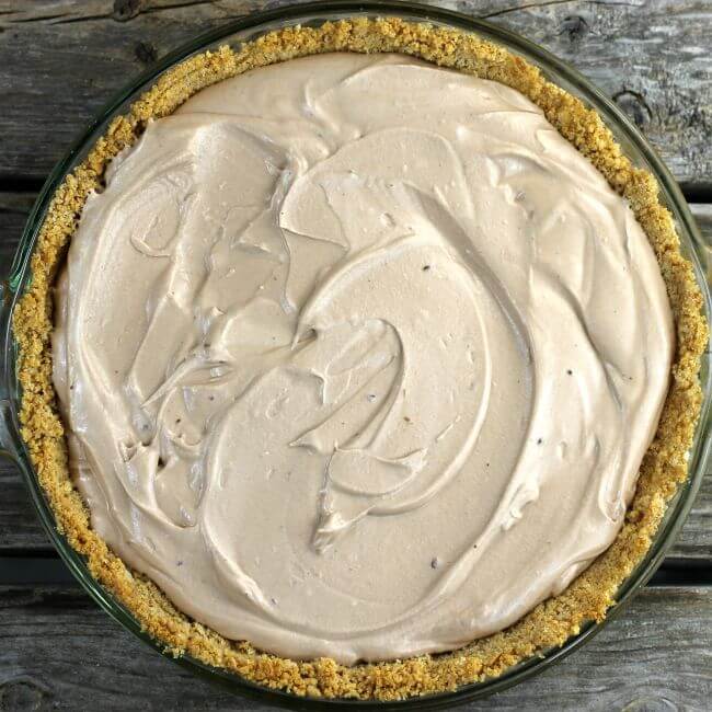 Whipped chocolate filling added to a graham cracker crust
