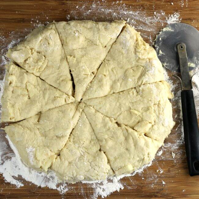 The dough is formed in a circle and cut into wedges.