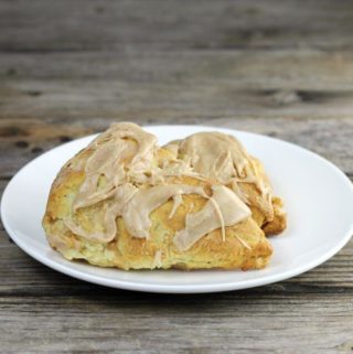 Two apple scones on a white plate.