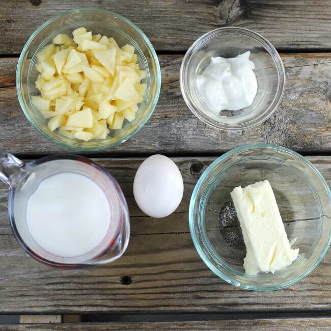 Butter, sour cream, milk, an egg, and chopped apples.
