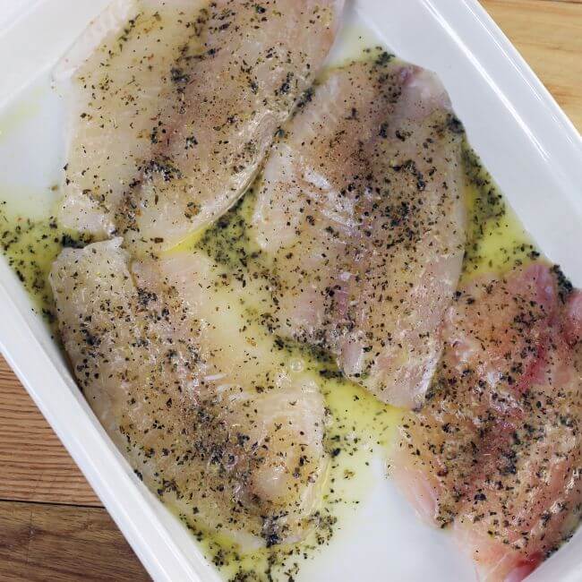 A butter mixture is drizzled over top of the fish.