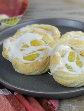 A side angle view of lemon pastries on a a gray plate.