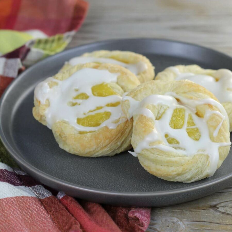 A side angle view of lemon pastries on a a gray plate.