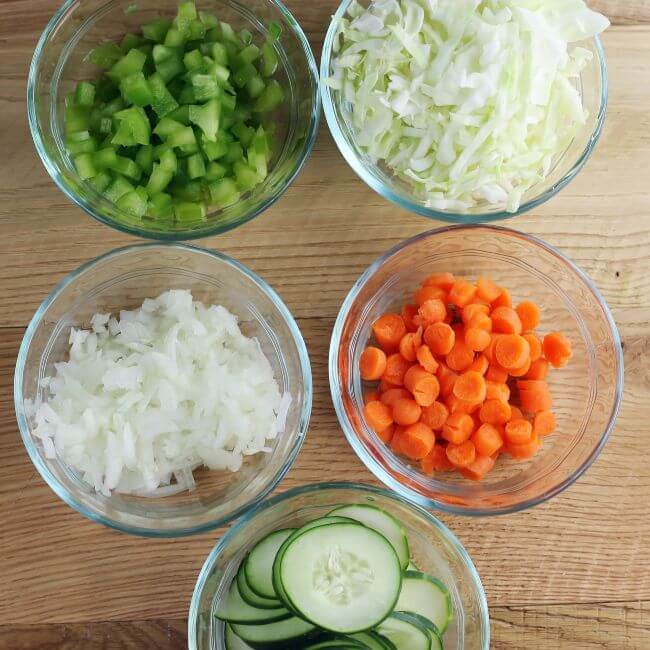 Small bowls of vegetables for cabbage salad.