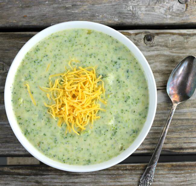 Over looking broccoli soup in a white bowl.