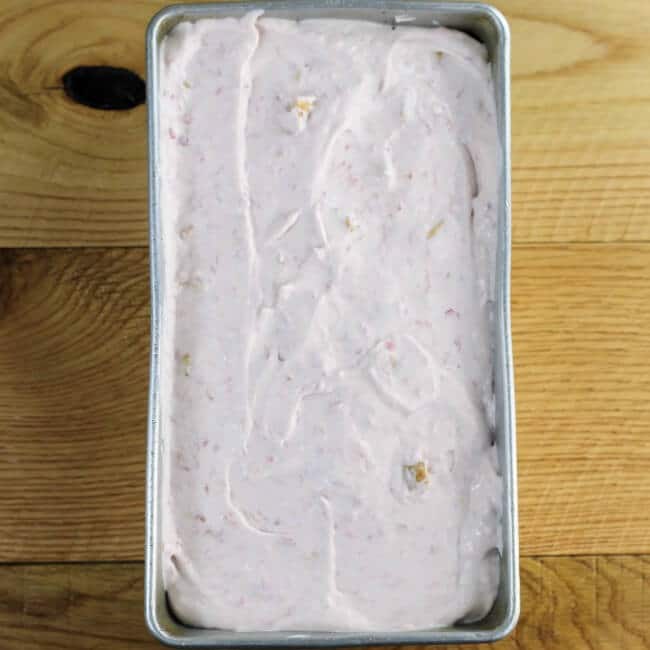 Raspberry cheese cake ice cream mixture in a loaf pan.