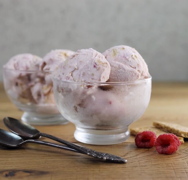 Side view of raspberry cream cheese ice cream in glass bowls.