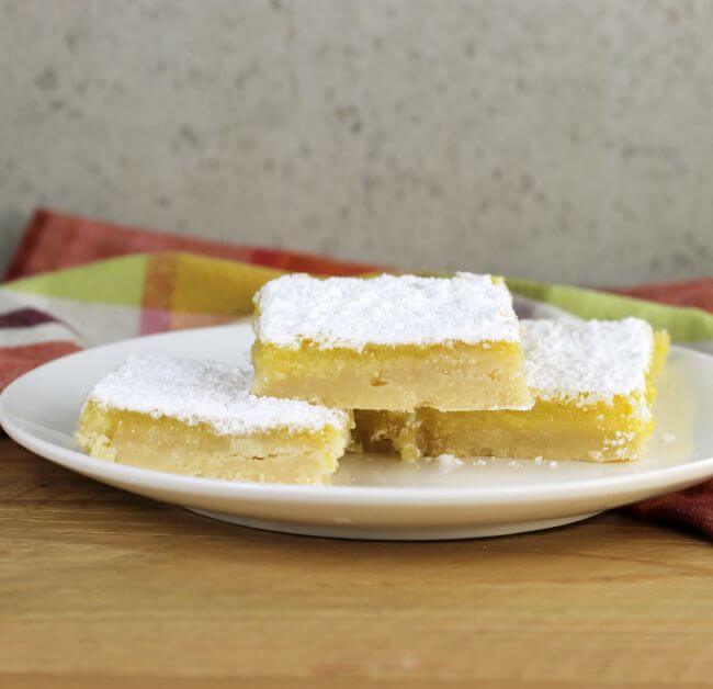 Side view of a plate of lemon bars.