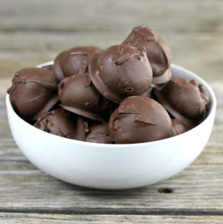Peanut butter balls in a white bowl.