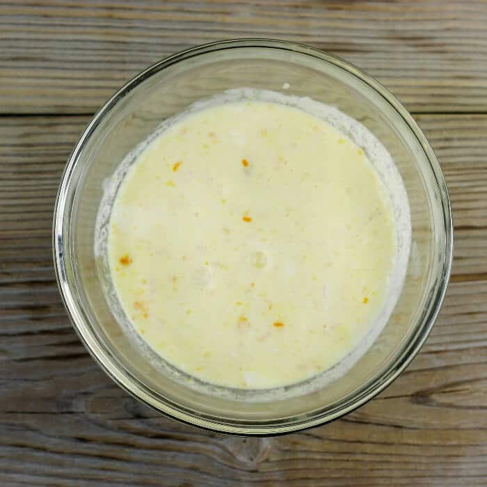 The orange juice, zest, egg, and cream are combined in a medium bowl.
