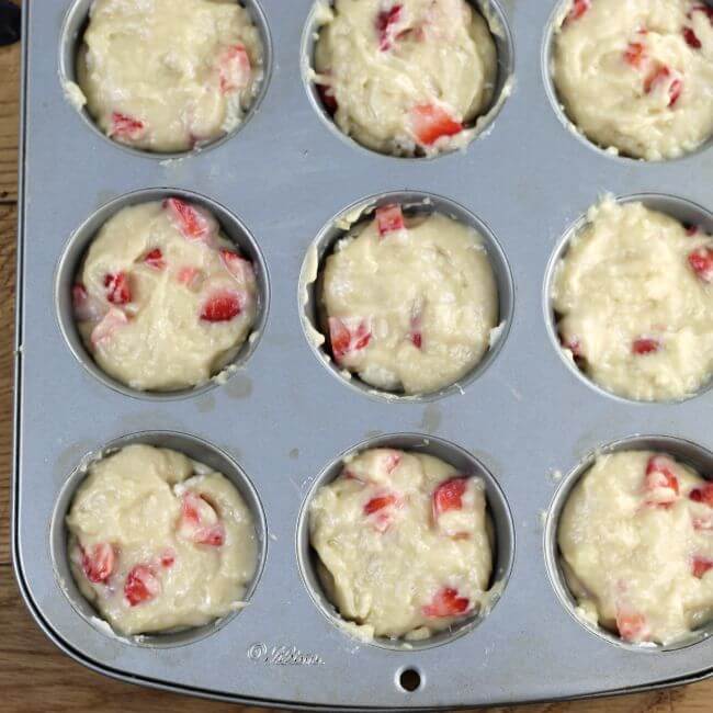Unbaked muffins in muffin tins.