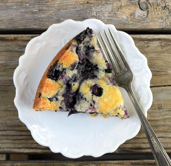 Overlooking a piece of kuchen on a white plate.