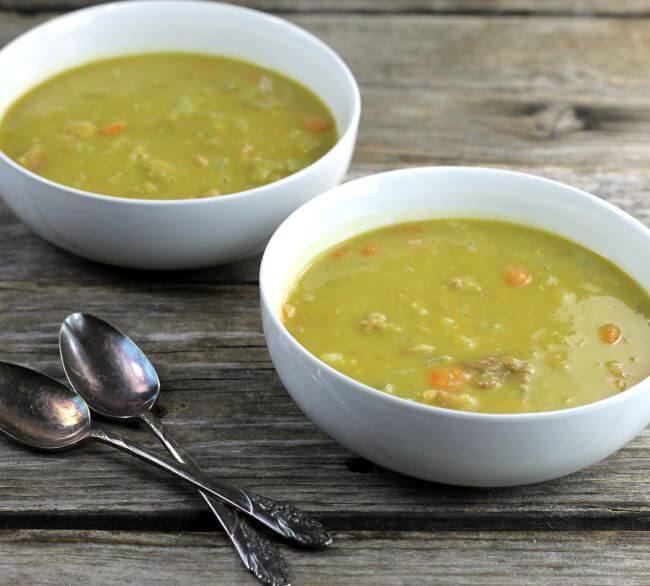 Two bowls of split pea soup, a side view.