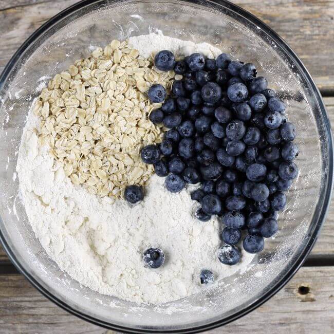 Blueberries and oatmeal is added to the flour mixture.