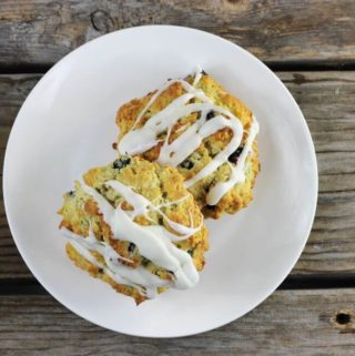 Looking down at two scones on a round white plate.