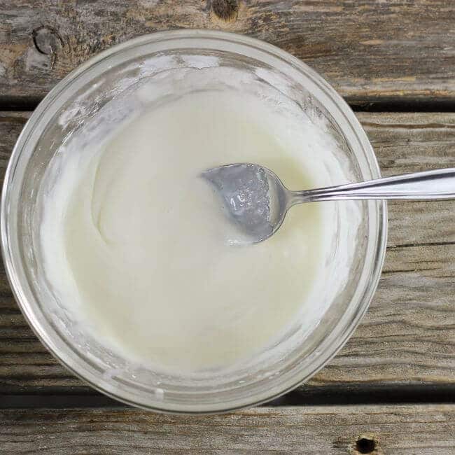 Icing with a spoon in a bowl.