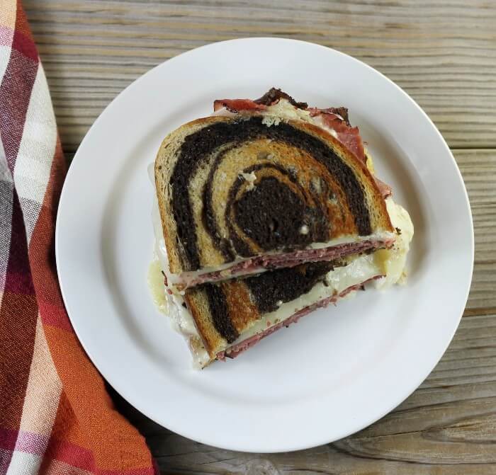 Looking down at a sandwich on a white plate.