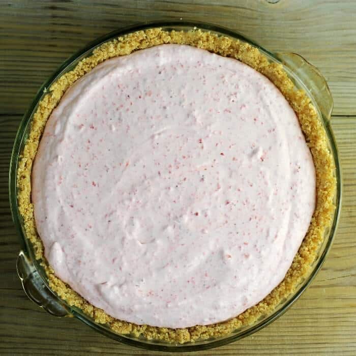 Looking down at a whipped strawberry pie. 