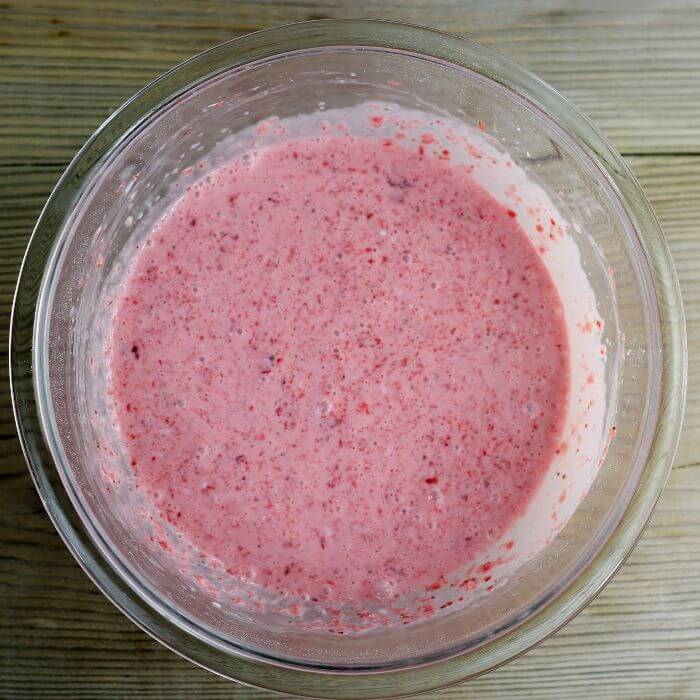 Cream cheese and strawberry mixture in a bowl.