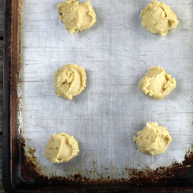 Cookie dough is dropped on the baking pan.