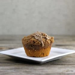 Side view of muffin on a white plate.