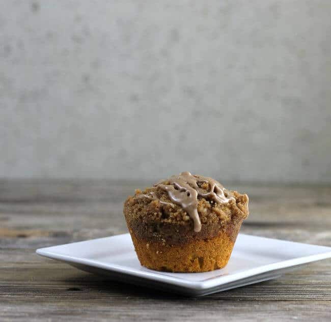 Side view of a muffin on a white square plate.