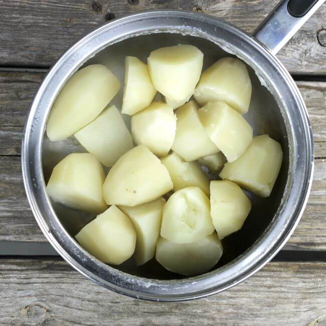 Potatoes that are cooked in a saucepan.
