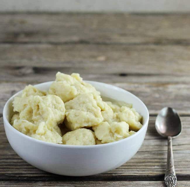 A side angle view of a bowl with egg dumplings.