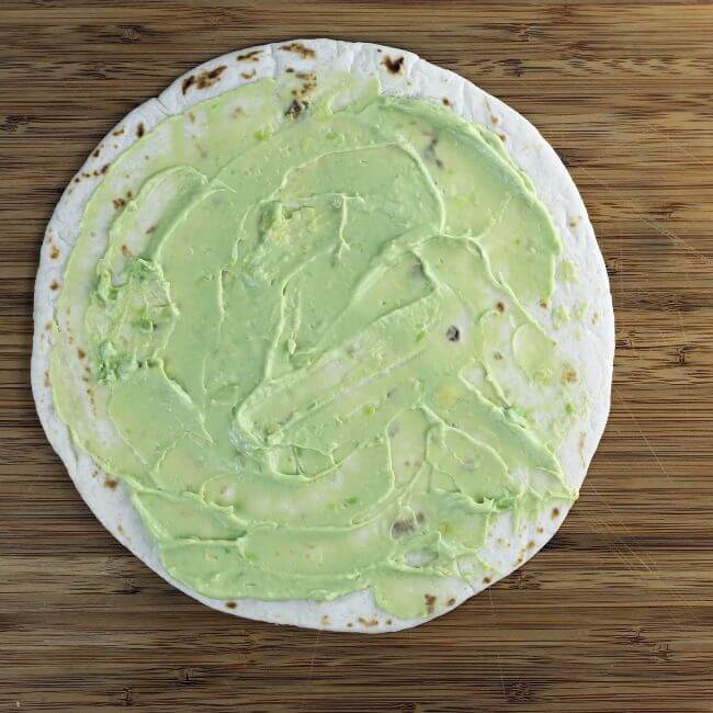 Tortilla shell spread with avocado mayo.