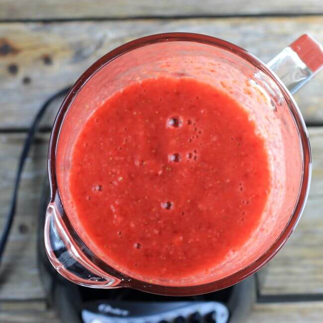 Pureed straberries in a blender.