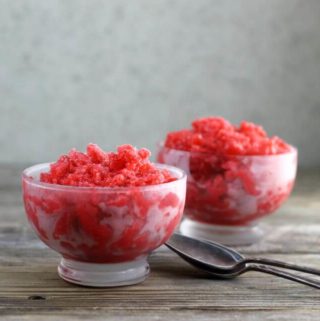 Side view of two bowls of Italian ice with spoons.