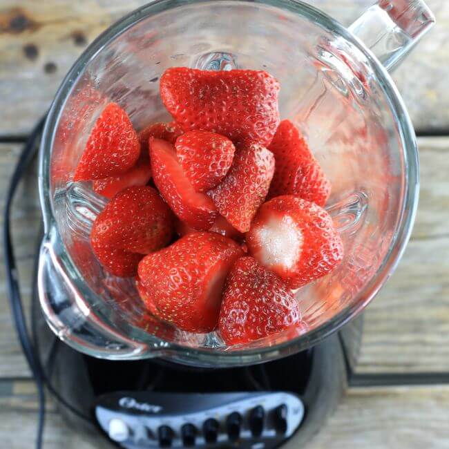 Strawberries added to a blender.