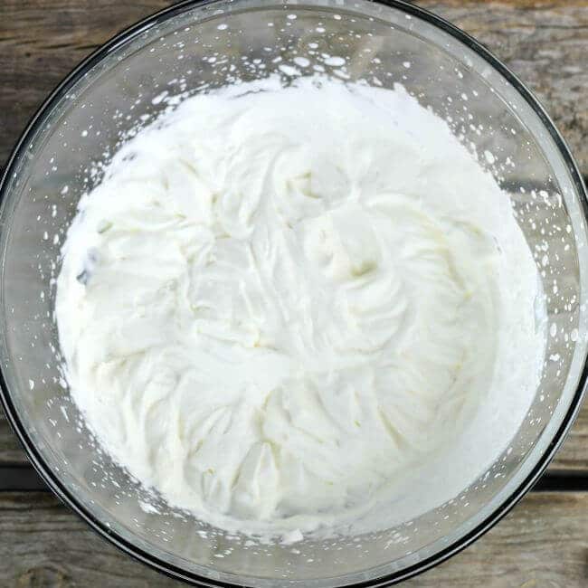 Whipped cream in a glass bowl.