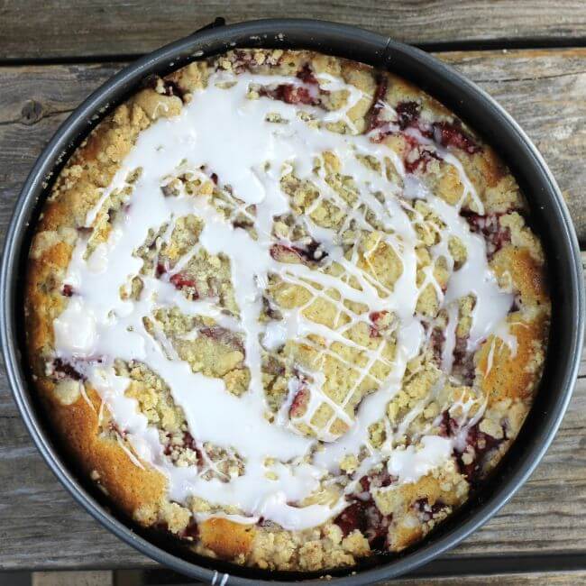 Icing is drizzled over top of coffee cake.