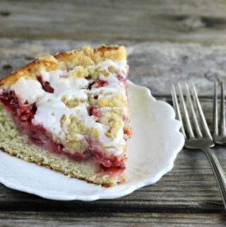 Side angle view of a slice of coffee cake with forks on the side.