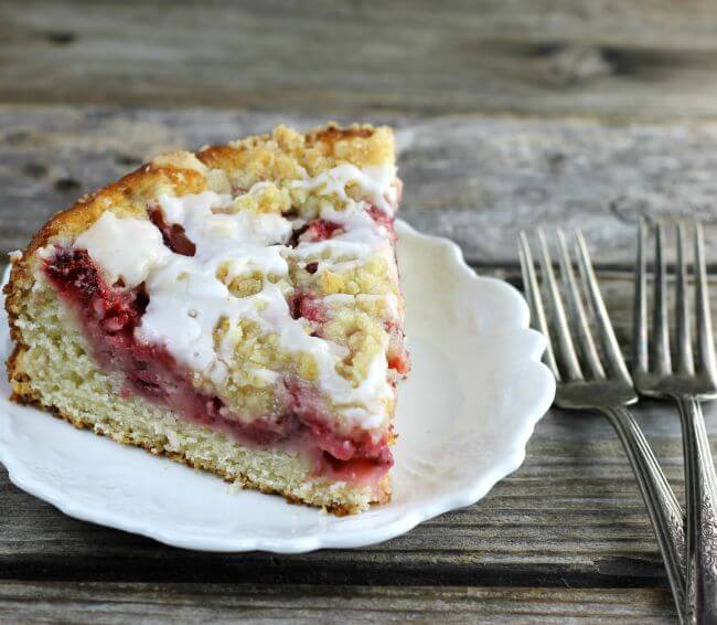 Side angle view of a slice of coffee cake with forks on the side.