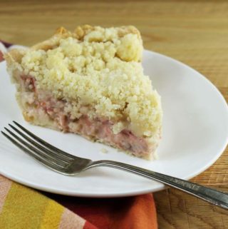 A slice of pie with a fork on a white plate.