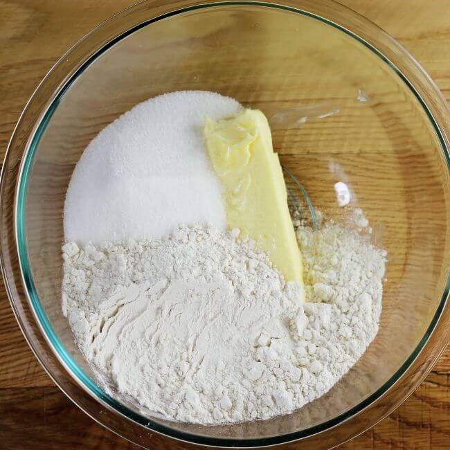 Buttet, sugar, and flour in a glass bowl.