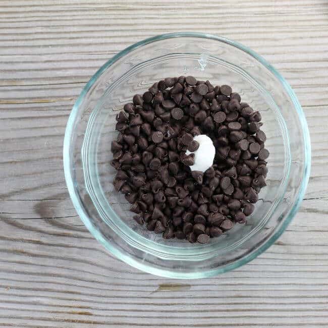 A small bowl with chocolate chips and a shortening. 