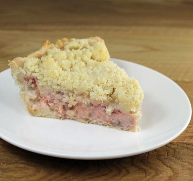 Side angle view of a slice of strawberry sour cream pie.